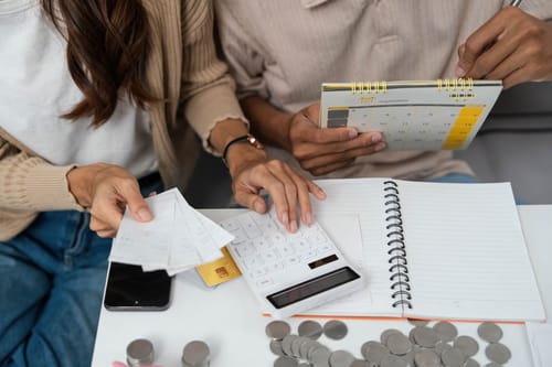 a couple budgeting together and managing their finances while calculating the cost of full time rv living